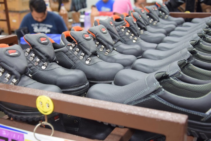 Rows of completed RHINO SHOE safety boots at the finishing stage