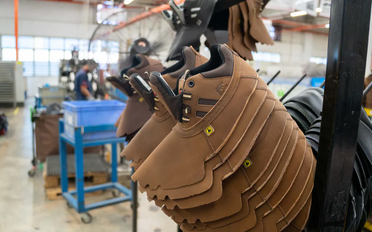 Completed brown leather RHINO SHOE uppers arranged for in-process checking