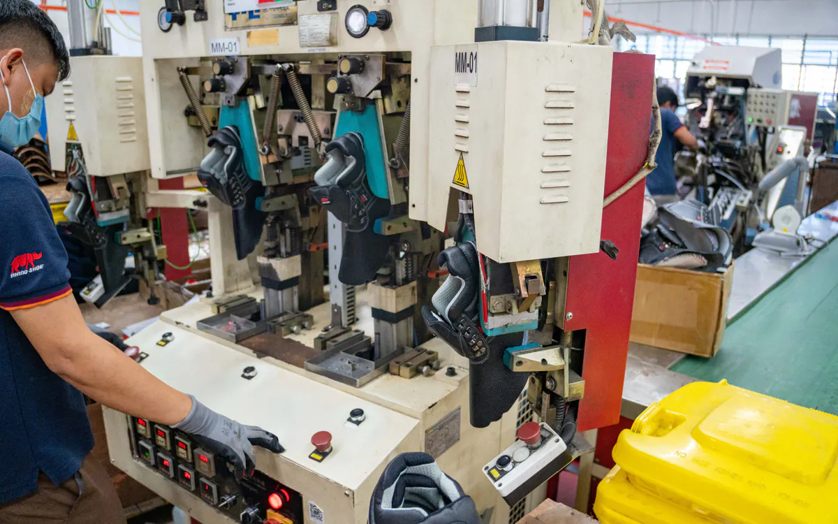RHINO SHOE operator controlling machinery that forms safety footwear uppers