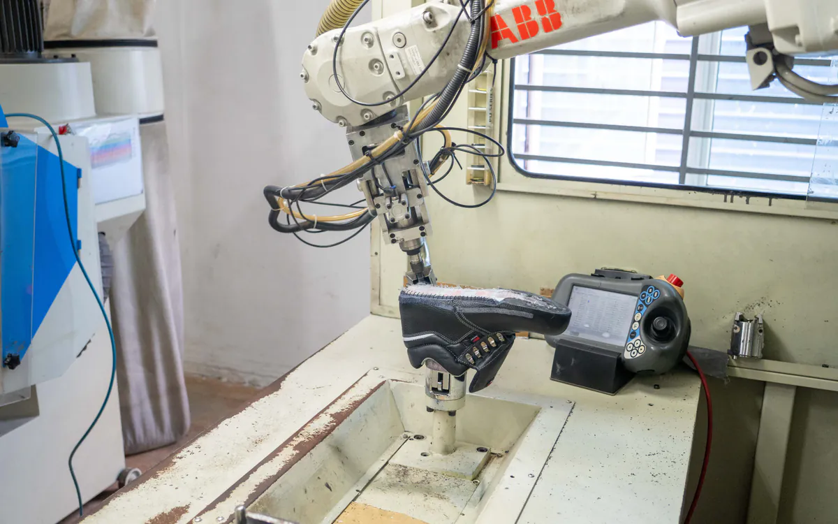 ABB robotic equipment performing precision work on a RHINO SHOE safety boot